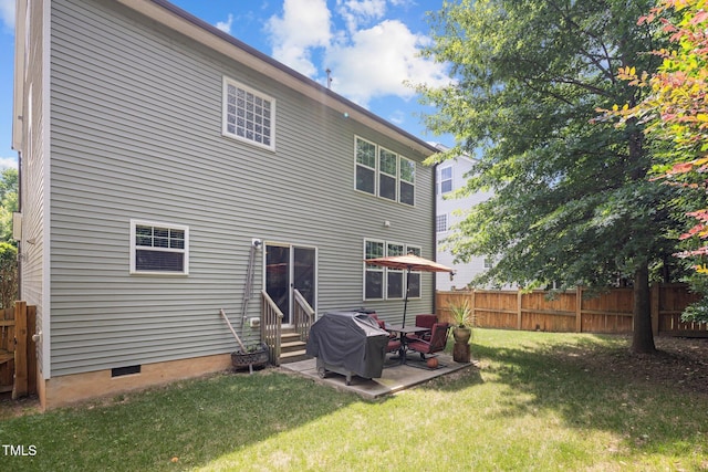 rear view of house with a patio area and a lawn