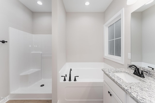 bathroom featuring vanity and a tub to relax in