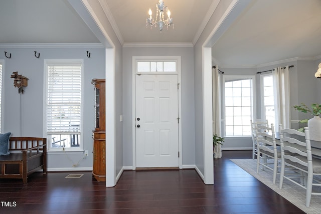 entrance foyer with crown molding, dark hardwood / wood-style floors, and a chandelier