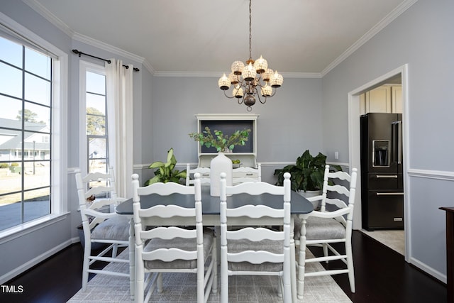 dining space with an inviting chandelier, plenty of natural light, crown molding, and hardwood / wood-style flooring