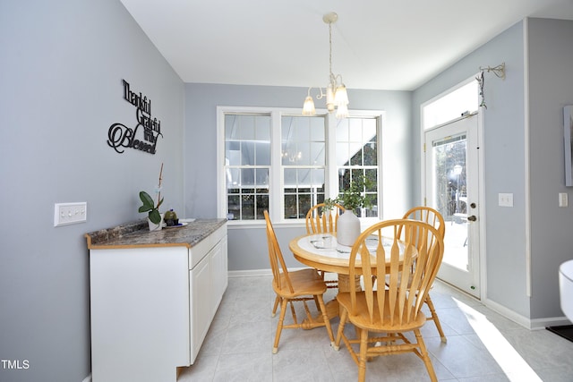 dining area with a notable chandelier and light tile patterned floors