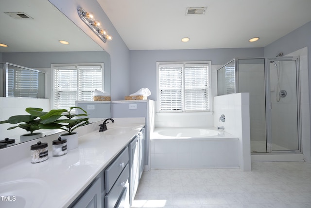 bathroom featuring vanity, plenty of natural light, and plus walk in shower