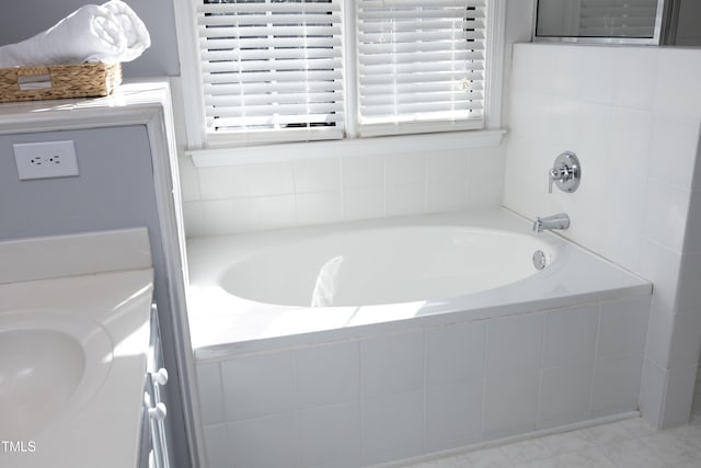 bathroom with a relaxing tiled tub