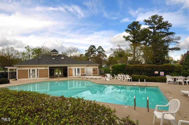 view of swimming pool with french doors and a patio area