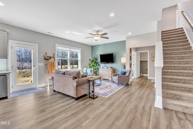 living room featuring light wood-type flooring and ceiling fan