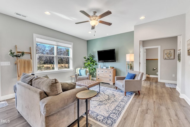 living room featuring ceiling fan and light wood-type flooring