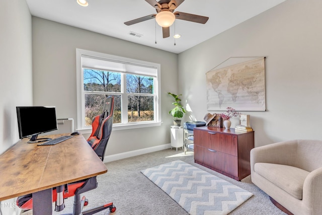 carpeted office space featuring ceiling fan