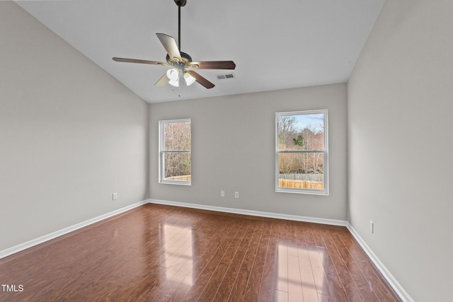 empty room featuring a healthy amount of sunlight, visible vents, baseboards, and wood finished floors