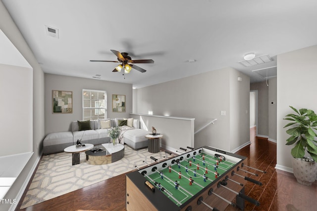 playroom with attic access, visible vents, baseboards, and wood finished floors