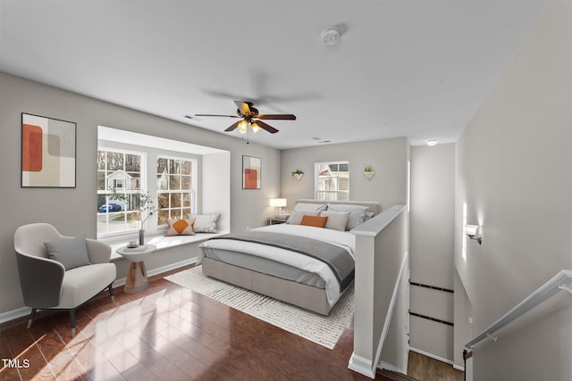 bedroom featuring a ceiling fan, baseboards, and wood finished floors