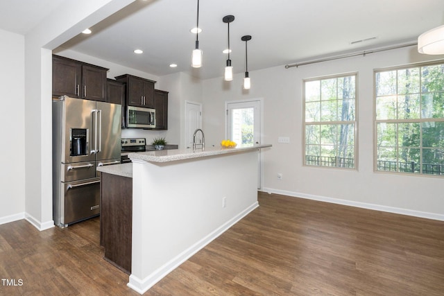 205 Spring Flower Ln, Durham, NC 27703 - kitchen featuring dark wood-style flooring, recessed lighting, dark brown cabinets, a healthy amount of sunlight, and appliances with stainless steel finishes