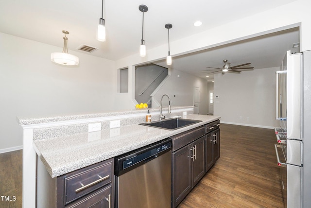 205 Spring Flower Ln, Durham, NC 27703 - kitchen with appliances with stainless steel finishes, a kitchen island with sink, visible vents, dark wood finished floors, and a sink