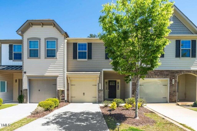 205 Spring Flower Ln, Durham, NC 27703 - townhome / multi-family property with an attached garage, driveway, and stone siding