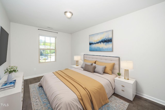 205 Spring Flower Ln, Durham, NC 27703 - bedroom with baseboards and dark wood finished floors