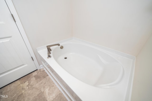 205 Spring Flower Ln, Durham, NC 27703 - bathroom featuring a bath and stone finish flooring