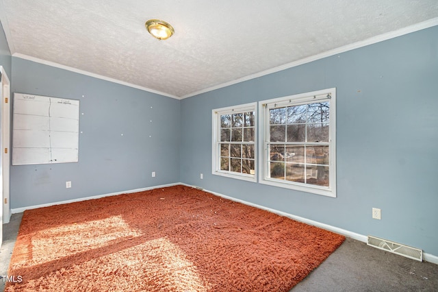 carpeted spare room with a textured ceiling and crown molding