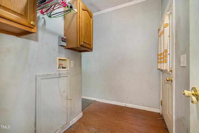 laundry room featuring dark hardwood / wood-style flooring, a textured ceiling, washer hookup, and ornamental molding