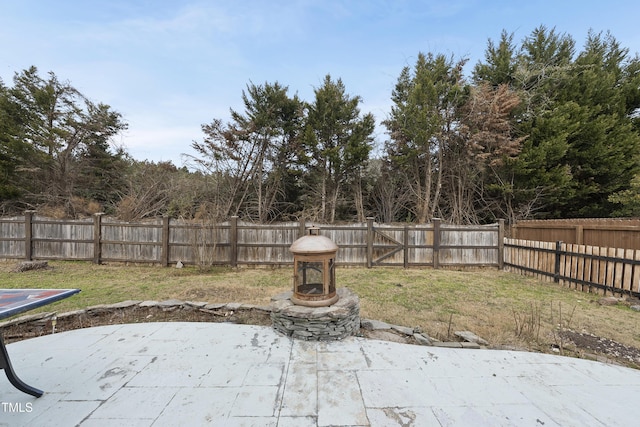 view of patio / terrace with a trampoline and an outdoor fire pit