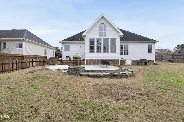 back of property featuring a lawn and a patio