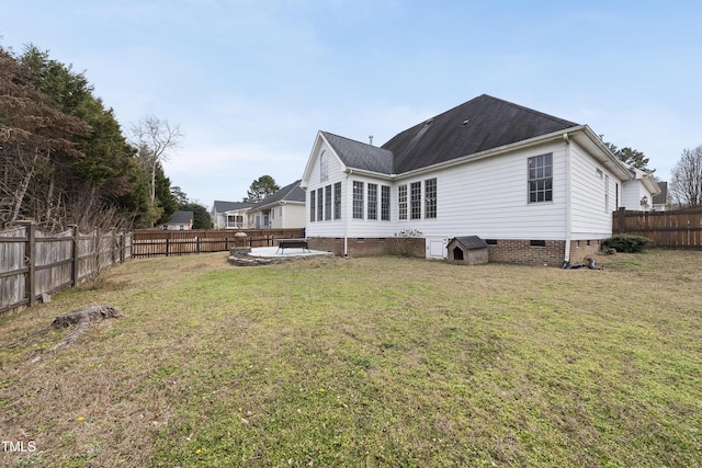 back of house with a lawn