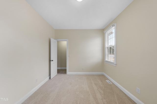 unfurnished room with light colored carpet