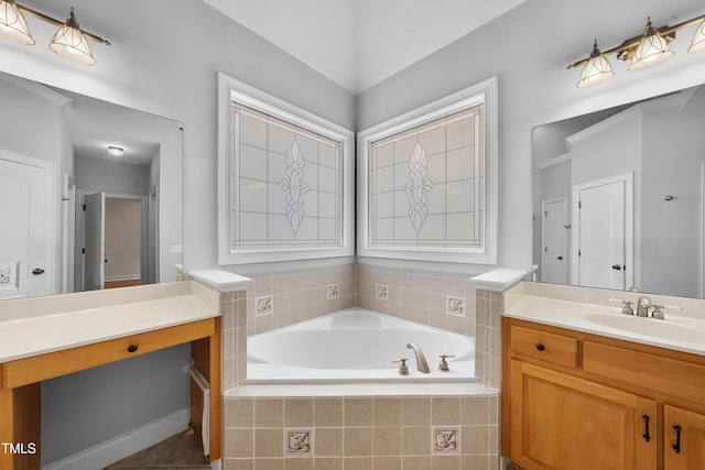 bathroom with vanity, a relaxing tiled tub, and tile patterned floors