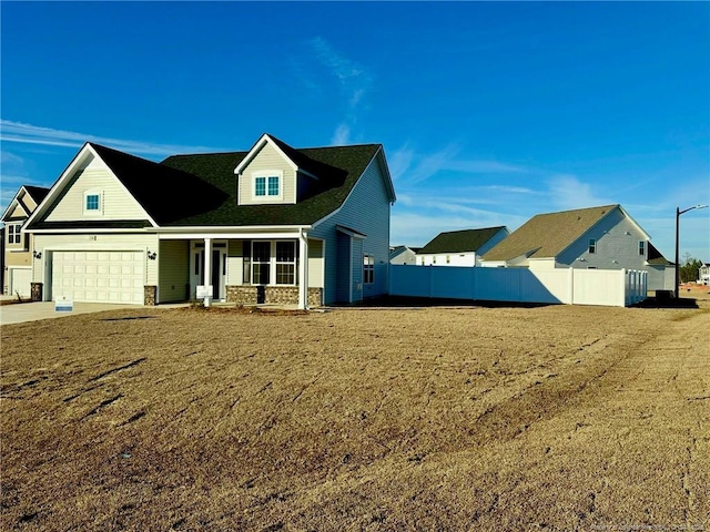 view of front of property with a garage, a front yard, and a porch