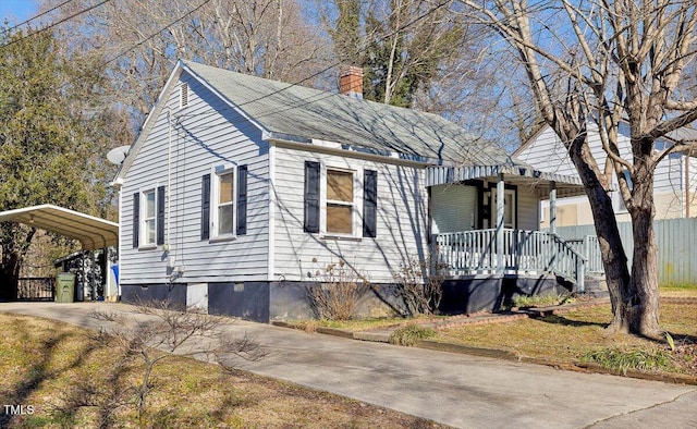 view of side of home with a carport