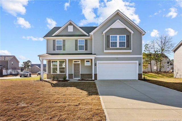 view of front of house with a porch, a garage, and a front lawn