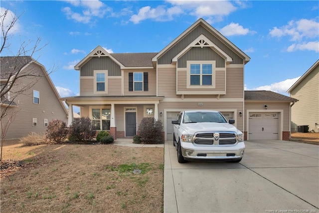 view of front of home featuring a garage, covered porch, and central air condition unit