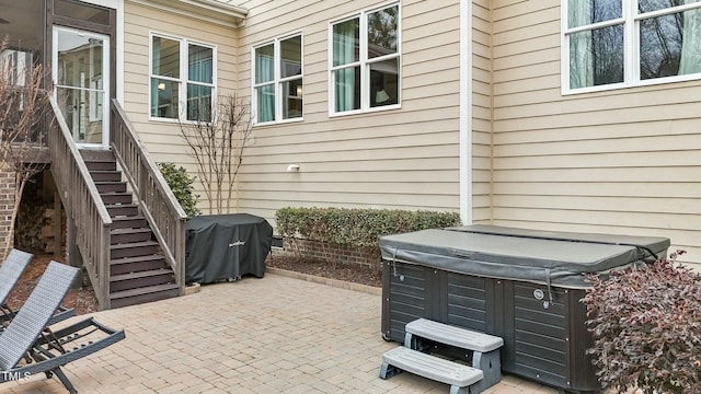 view of patio / terrace with a hot tub and a grill