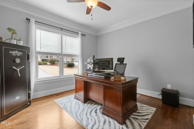 office area featuring wood-type flooring, ornamental molding, and a healthy amount of sunlight