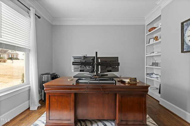 home office featuring ornamental molding, hardwood / wood-style floors, and built in features