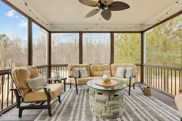 sunroom / solarium featuring ceiling fan