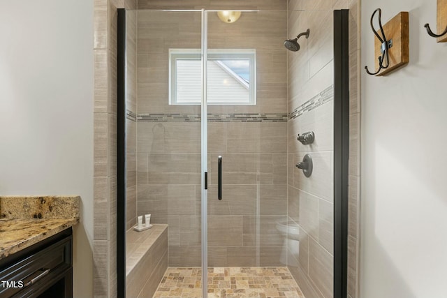 bathroom with vanity and a shower with door