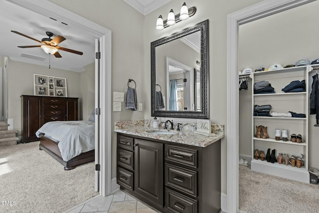 bathroom featuring ornamental molding, vanity, and ceiling fan