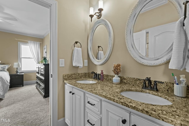 bathroom with ceiling fan, ornamental molding, and vanity