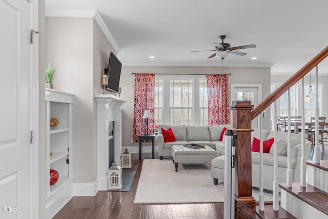 living room featuring ornamental molding, plenty of natural light, and dark wood finished floors