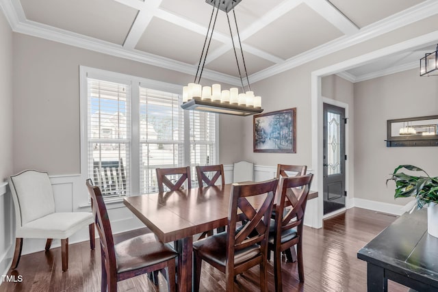 dining room featuring dark wood-style flooring, crown molding, a chandelier, coffered ceiling, and baseboards