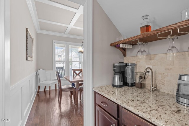 kitchen featuring coffered ceiling, dark wood finished floors, wainscoting, light stone countertops, and open shelves