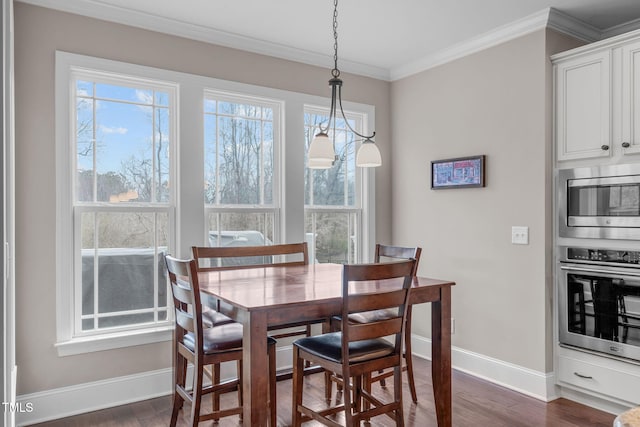 dining room featuring baseboards, ornamental molding, and dark wood-type flooring