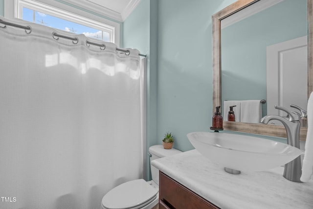 full bathroom featuring toilet, vanity, and crown molding