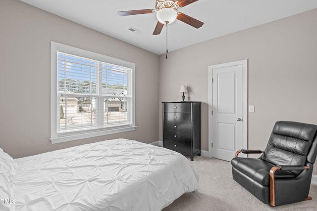 bedroom with ceiling fan, baseboards, visible vents, and light colored carpet