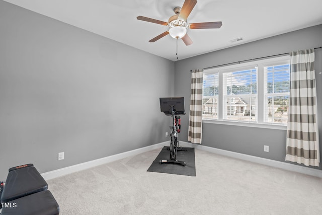 workout area with carpet flooring, a ceiling fan, and baseboards