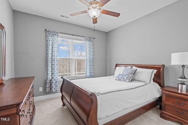 bedroom featuring a ceiling fan, light colored carpet, and baseboards