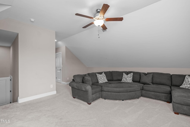 living area with light carpet, baseboards, vaulted ceiling, and a ceiling fan