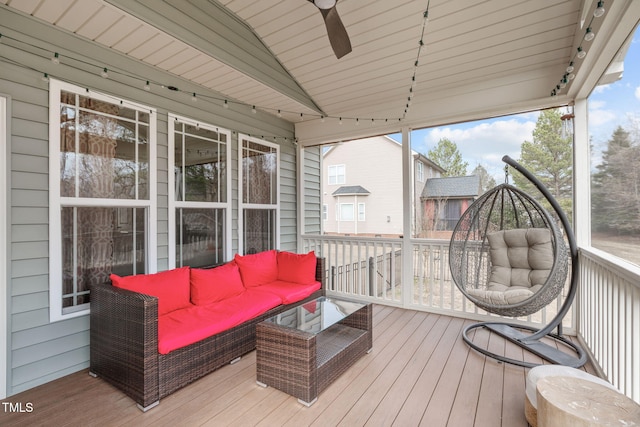 wooden terrace with ceiling fan and an outdoor hangout area