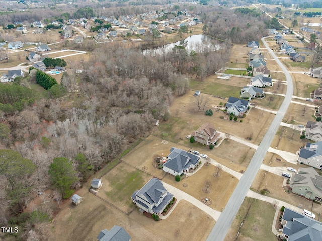 drone / aerial view with a water view and a residential view