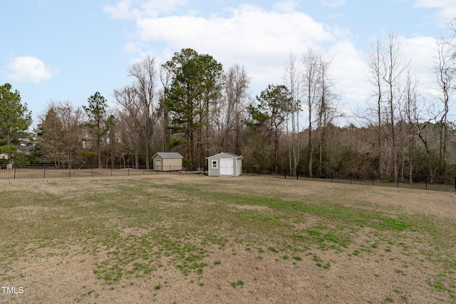 view of yard with an outdoor structure, fence, and a storage unit