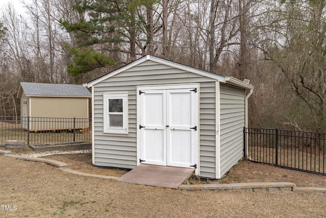 view of shed featuring fence